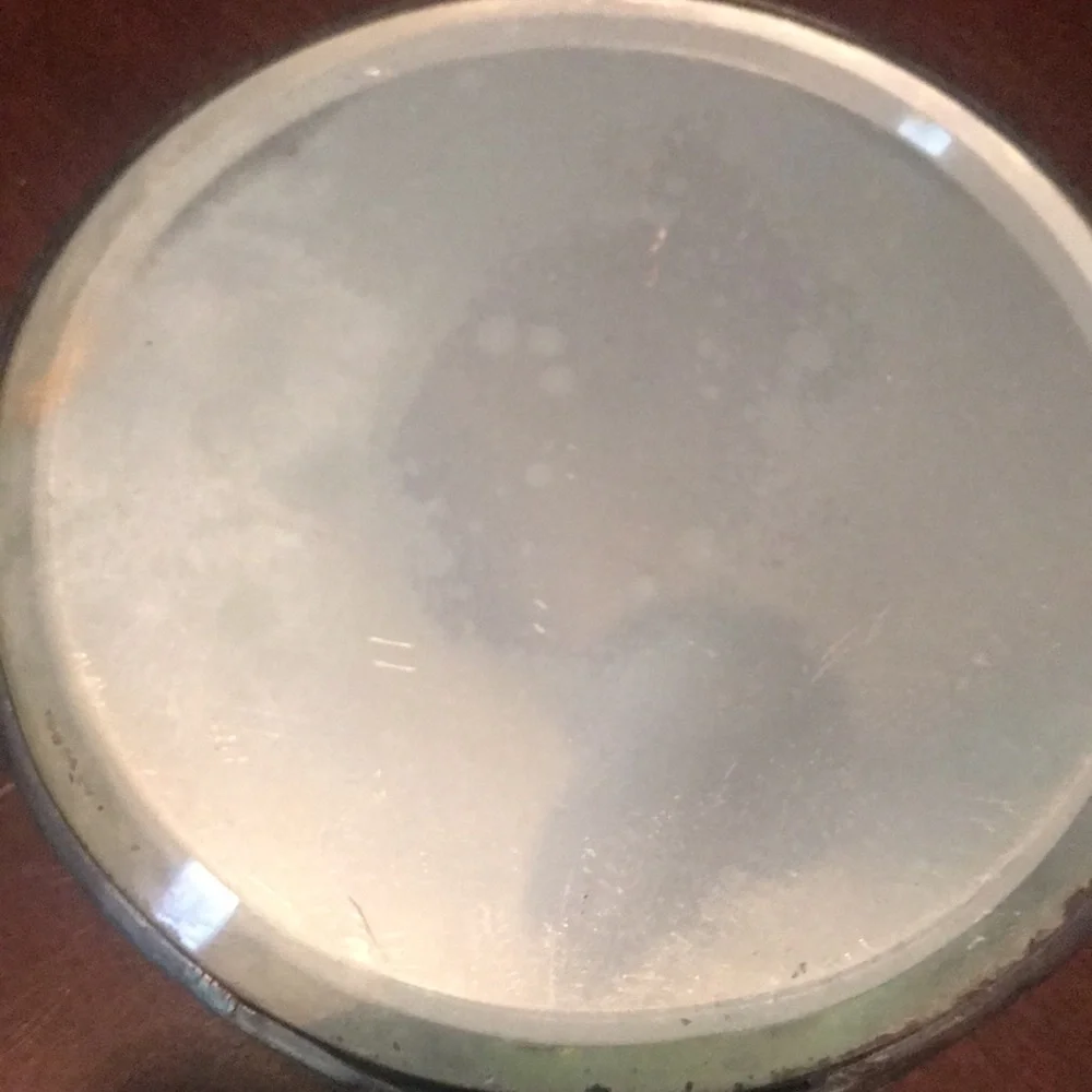 Vintage silver hand held mirror with raised flowers